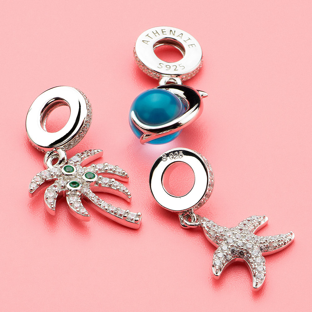 Lifestyle image of Aqua Dolphin dangle charm – beachy ocean jewelry