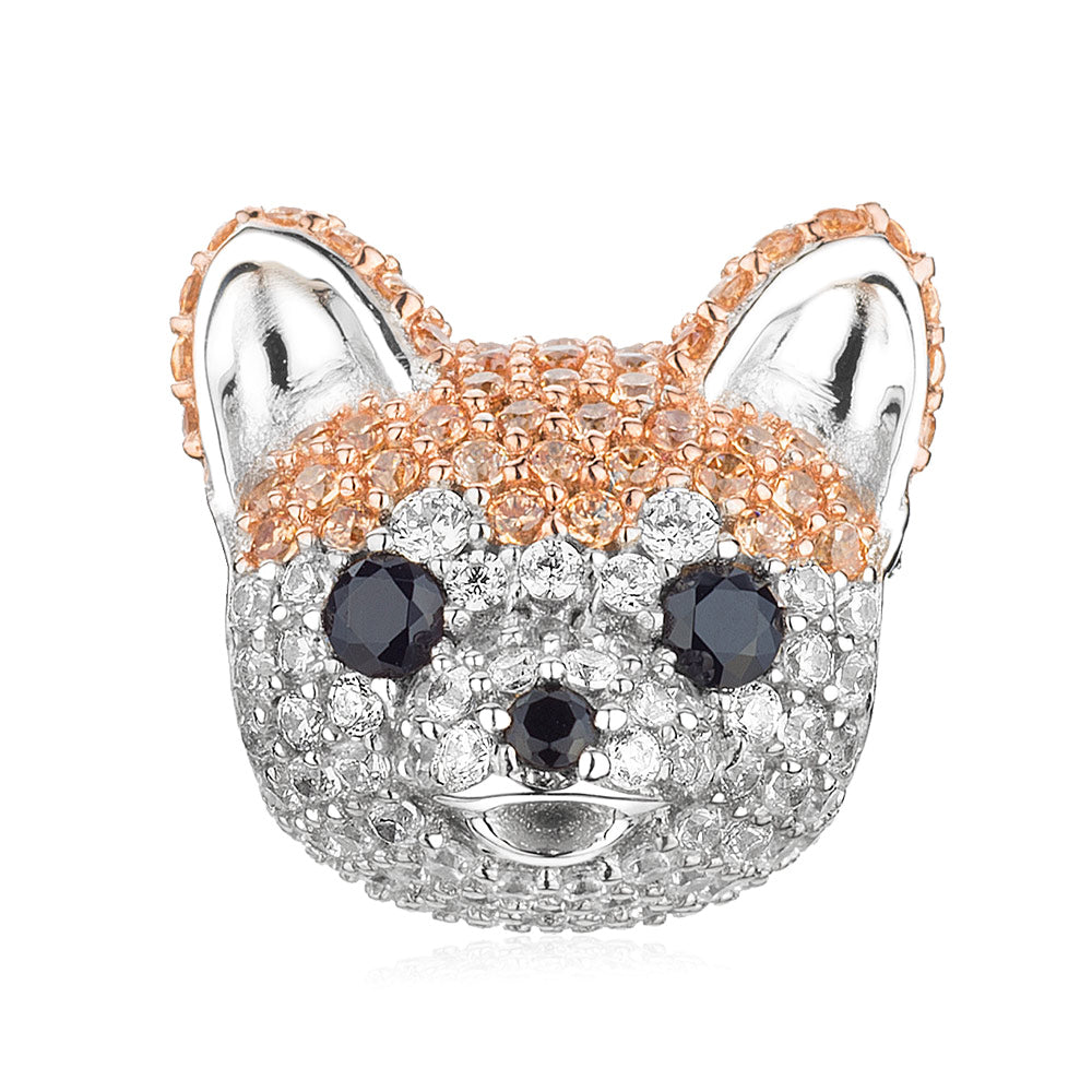 Front view of gold-plated Akita dog charm with CZ stones on white background