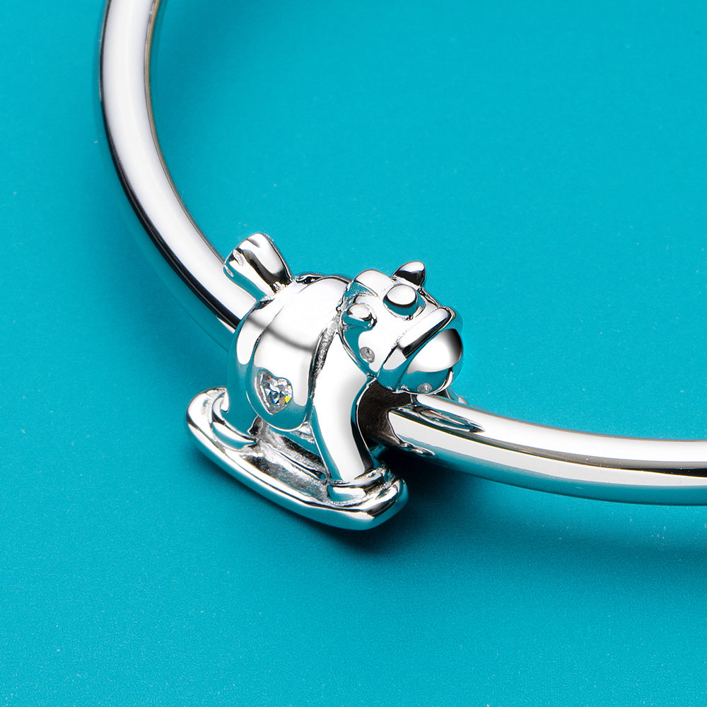 Sterling silver rocking horse charm in storytelling jewelry scene
