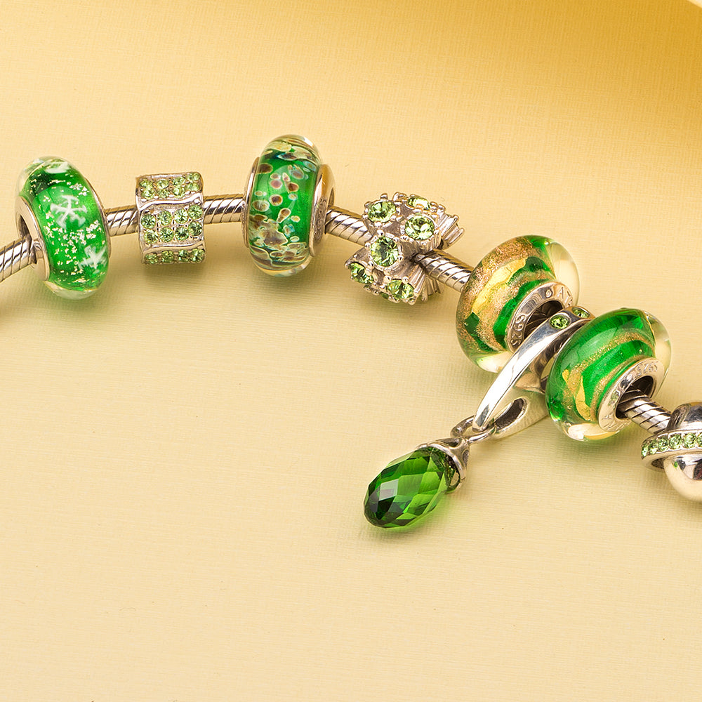 Emerald Gold Murano glass charm bead displayed in elegant jewelry scene.