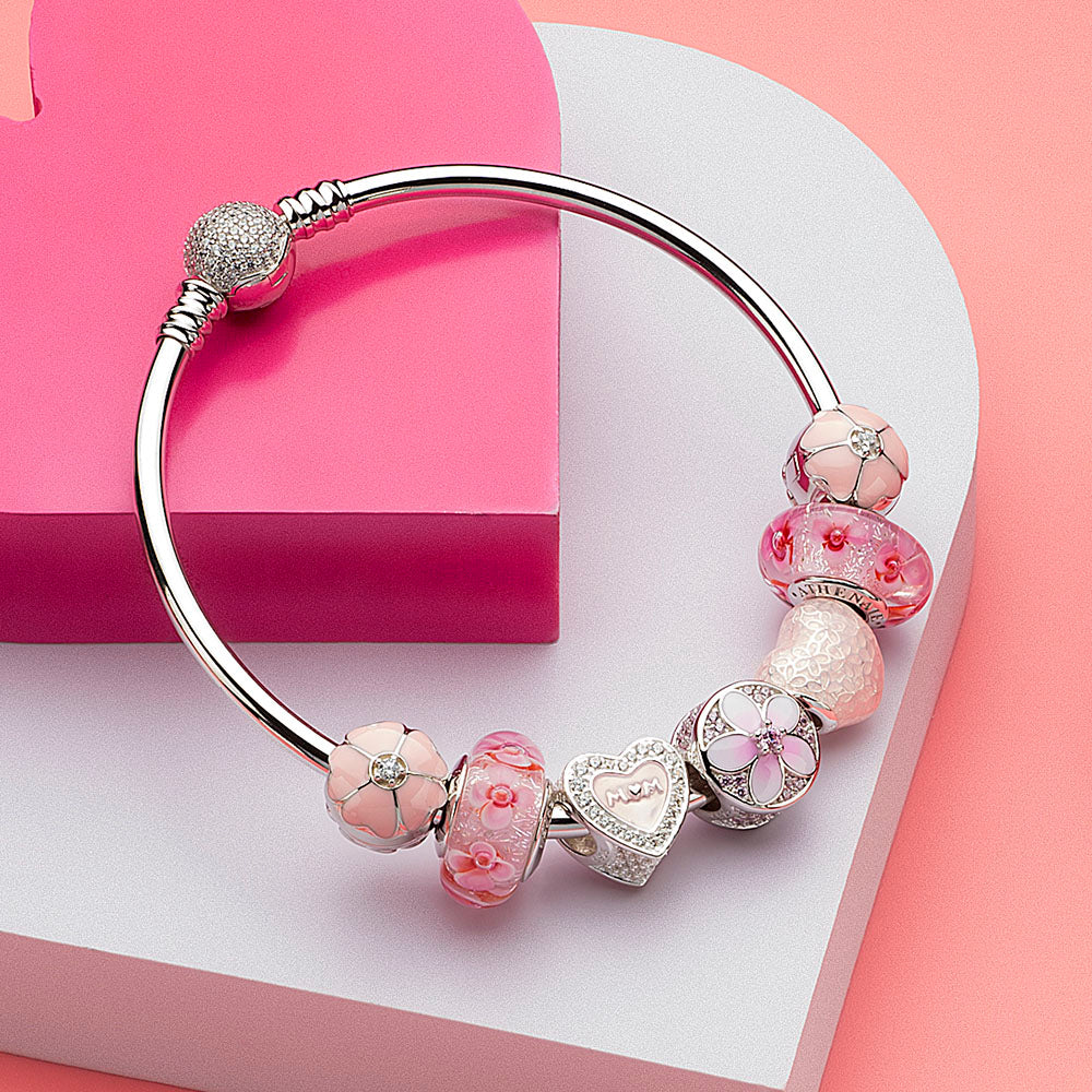 Sakura Lock charm clipped on ATHENAIE bracelet with matching floral and silver beads, styled for springtime elegance