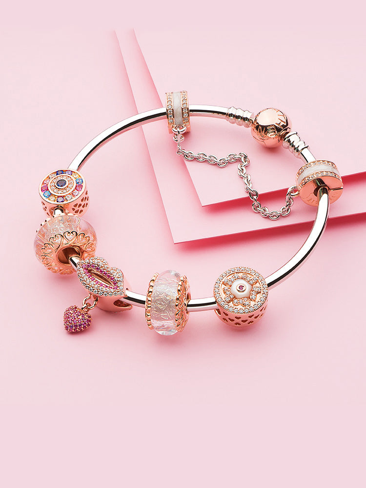 sterling silver charm bangle bracelet with rose gold clasp styling with charms
