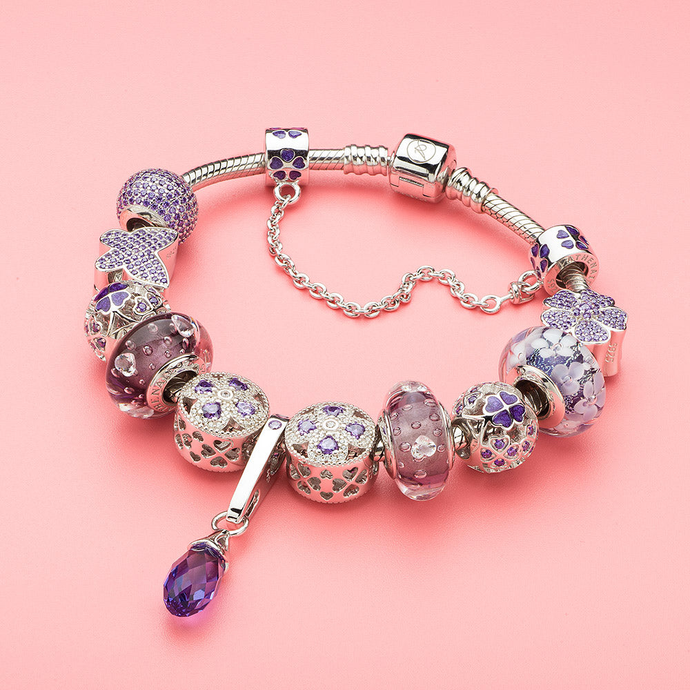 Amethyst Clover charm bead styled with purple and floral beads on silver bracelet, elegant and nature-inspired jewelry