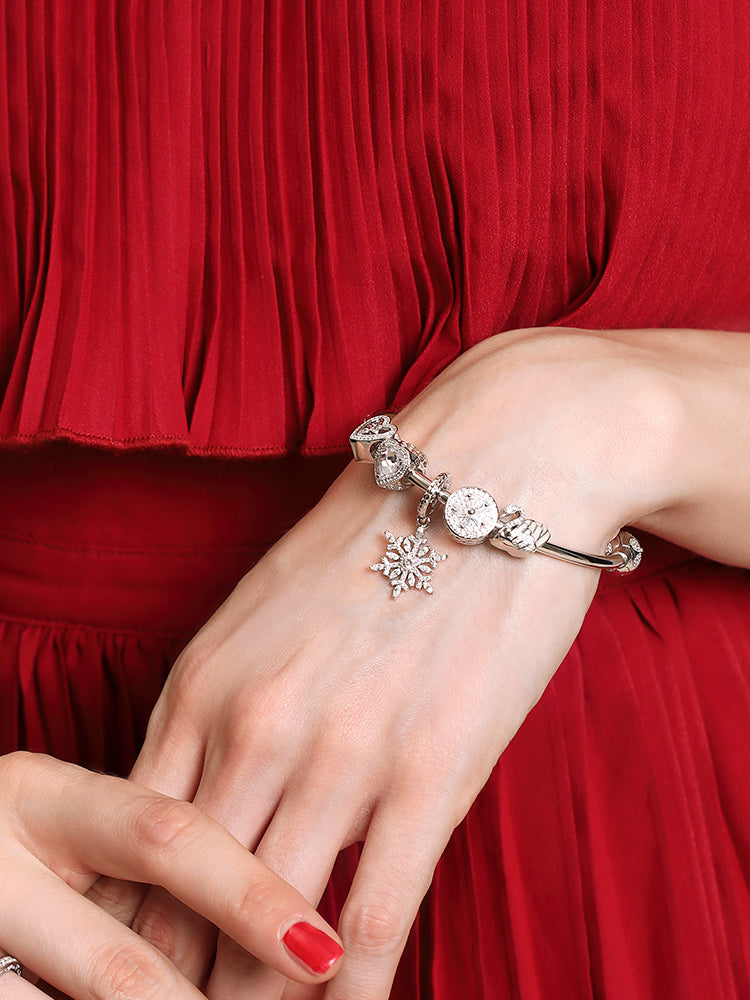 Model wearing angel heart charm bracelet in sterling silver