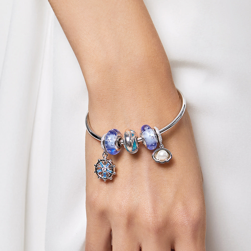 Model wearing Blue Horizon Murano glass charm bead 925 silver bracelet