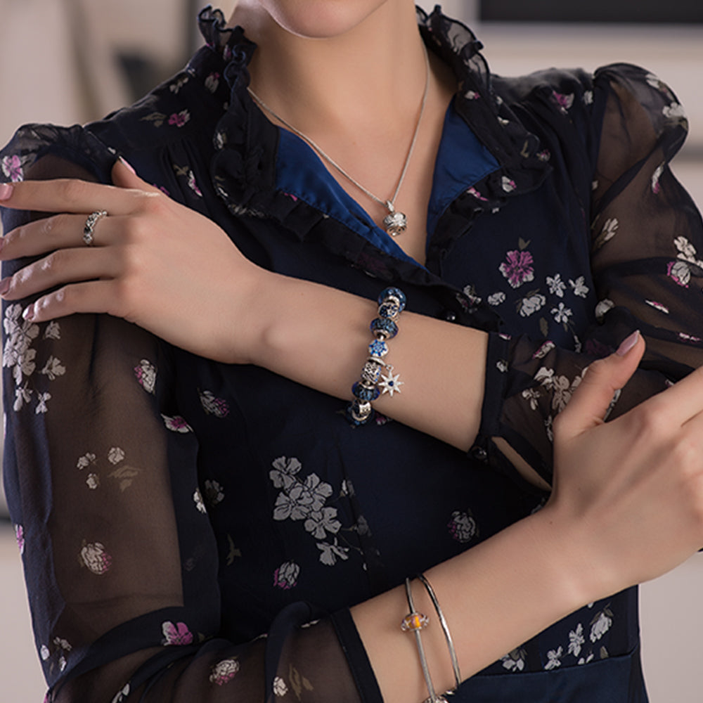 Model wearing ATHENAIE Blue Snowflake Charm Bead – stylish winter jewelry look