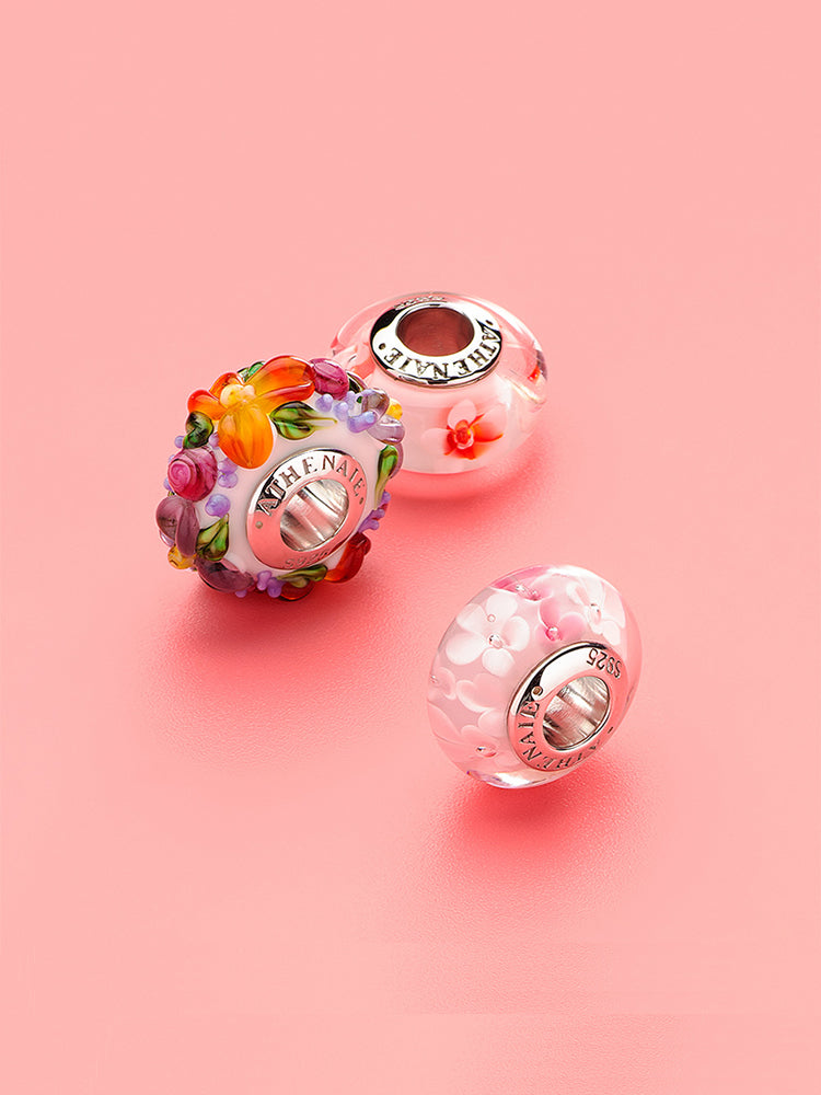 Bohemian floral Murano glass bead styled on a European charm bracelet, showcasing handcrafted glass artistry and elegant shine