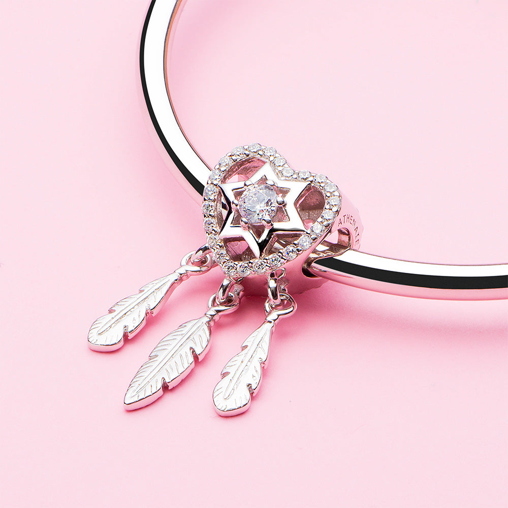 Lifestyle view of ATHENAIE Dreamcatcher Heart 925 sterling silver charm bead with CZ stones on bracelet