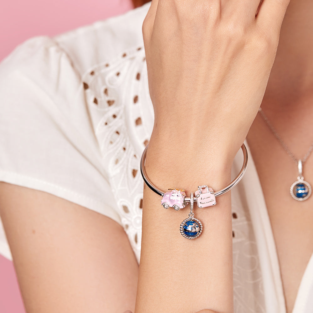 Model wearing ATHENAIE Love Travels Charm Bead – travel-inspired jewelry look 1
