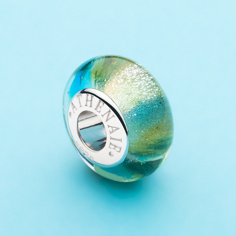 Rainbow Glow Murano glass charm bead with colorful rainbow design scene view
