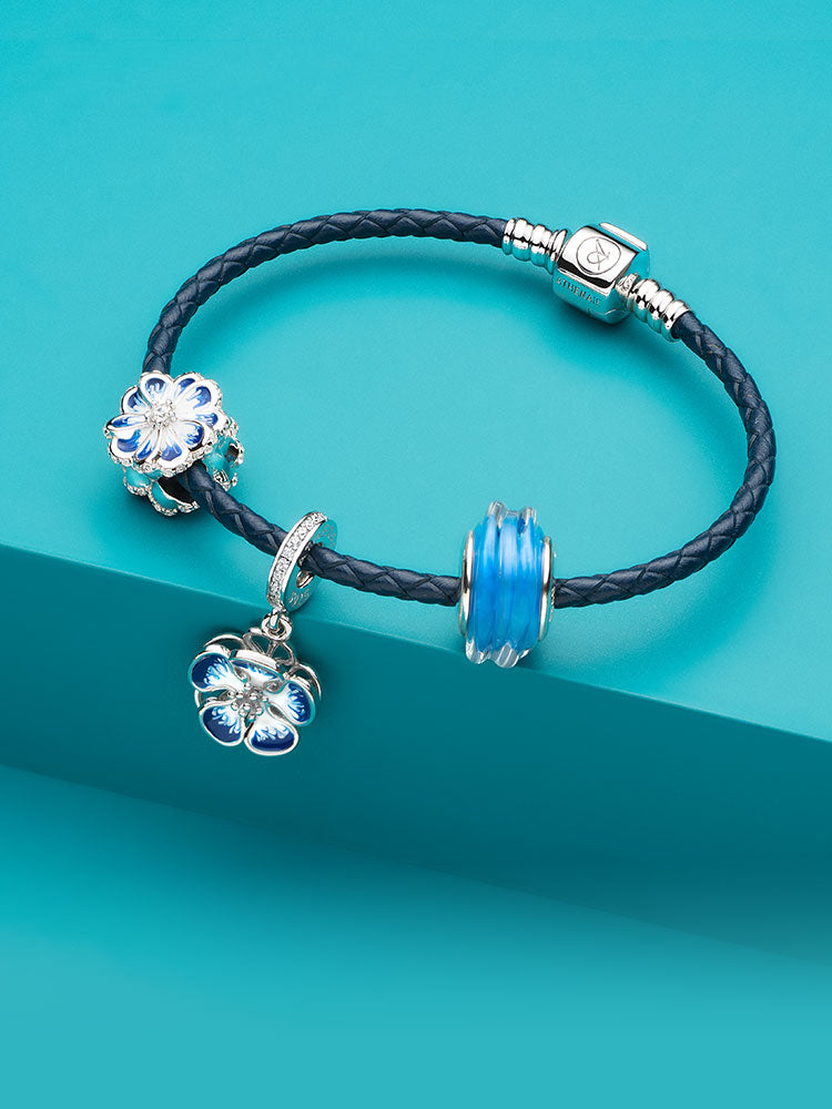 Azure bloom enamel dangle charm styled with other charms on bracelet