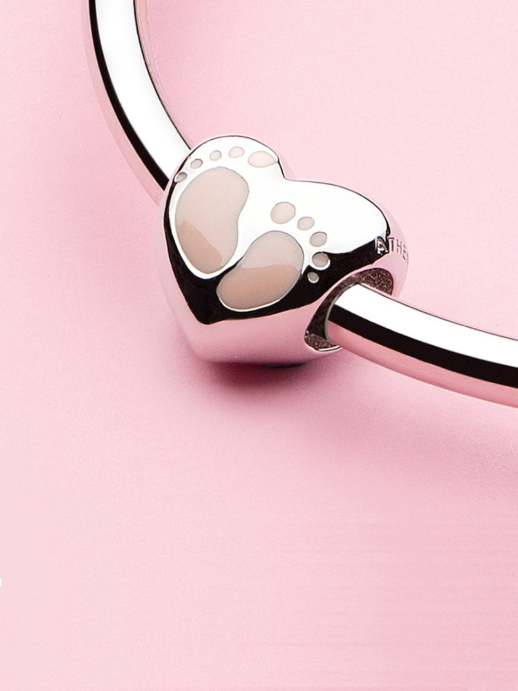 Tiny Steps baby footprint charm bead displayed on bracelet