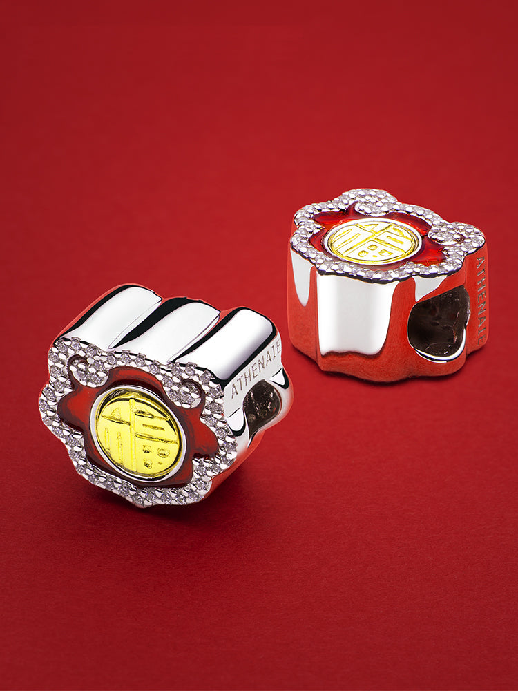 Blessing charm bead styled on charm bracelet symbolizing good fortune