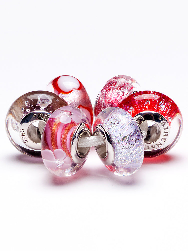Close view of blooming kiss murano glass charm on sterling silver charm bracelet