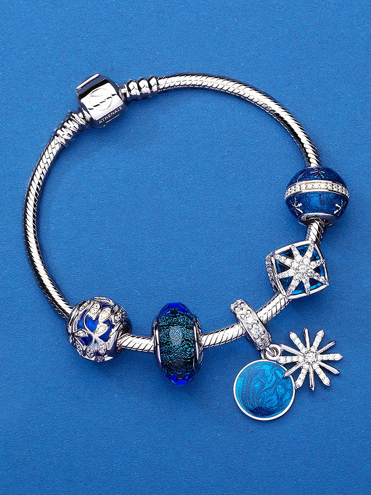 Blue enamel star dangle charm on a silver charm bracelet