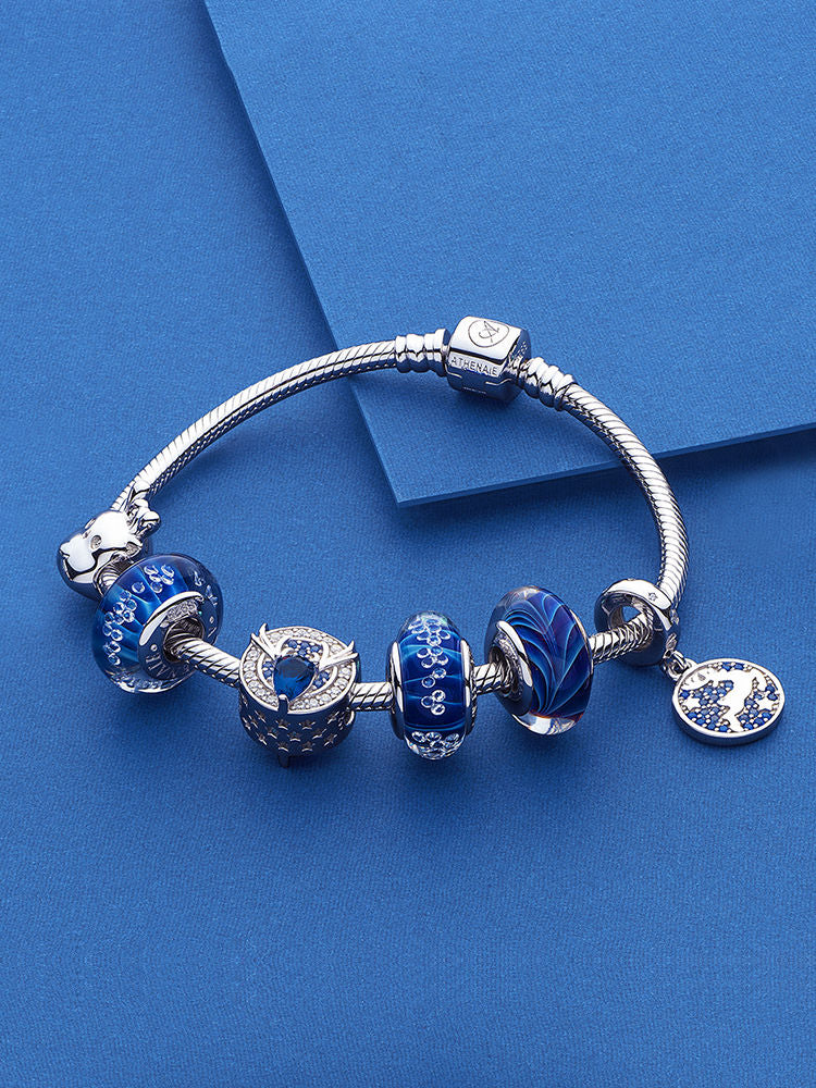 Blue murano glass charm styled on winter themed bracelet