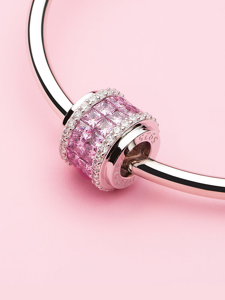 Blush Column sterling silver charm bead with pink CZ stones displayed on charm bracelet
