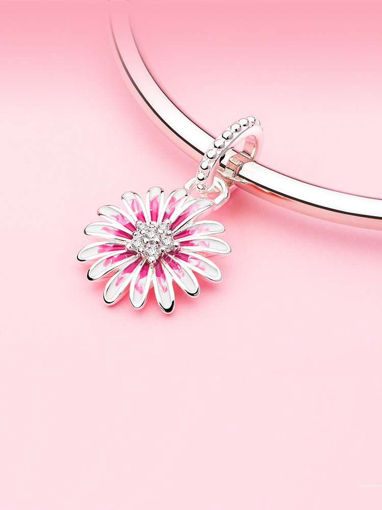 Blush Daisy sterling silver dangle charm displayed on charm bracelet