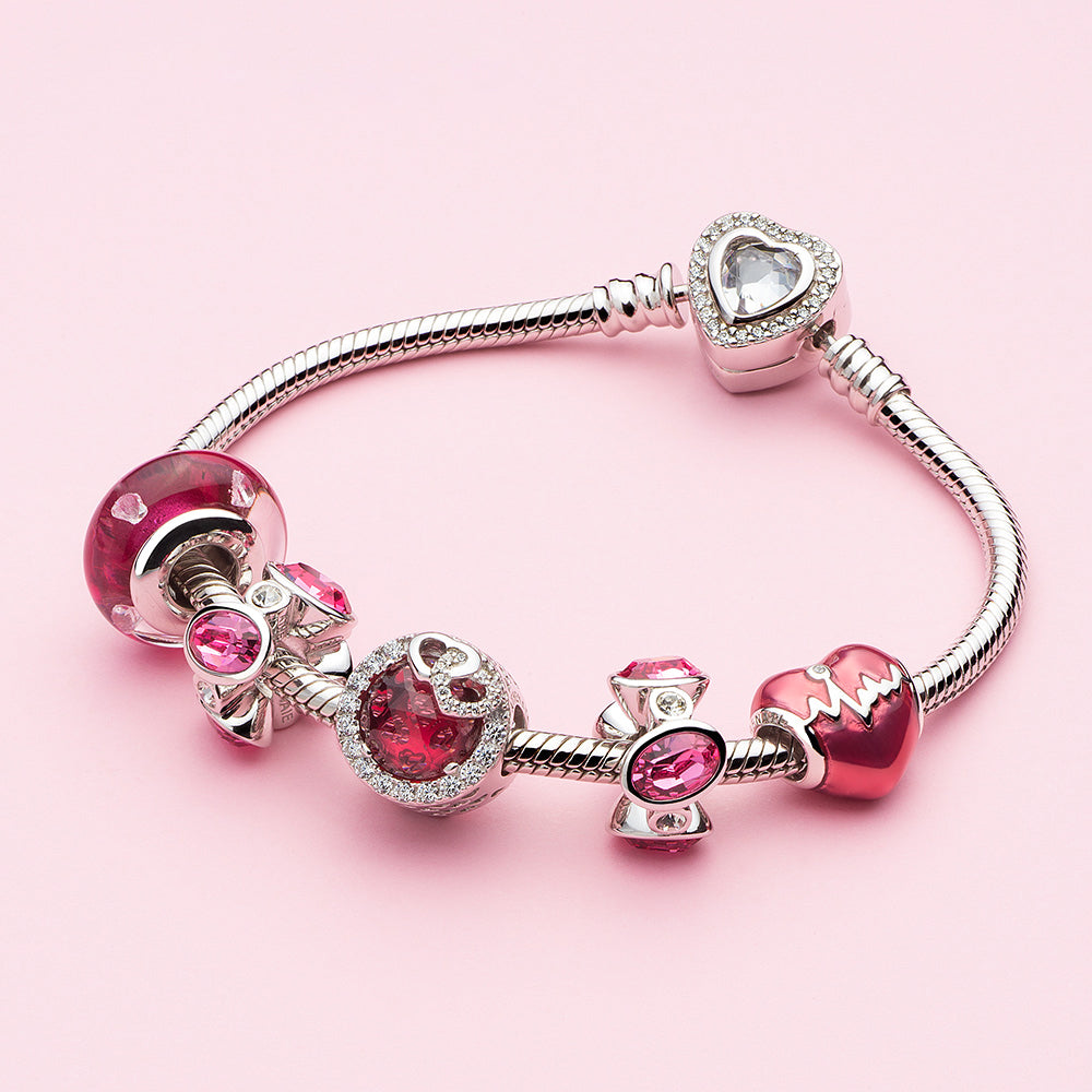 Blush Heart Murano glass charm bead paired with charm bracelet.