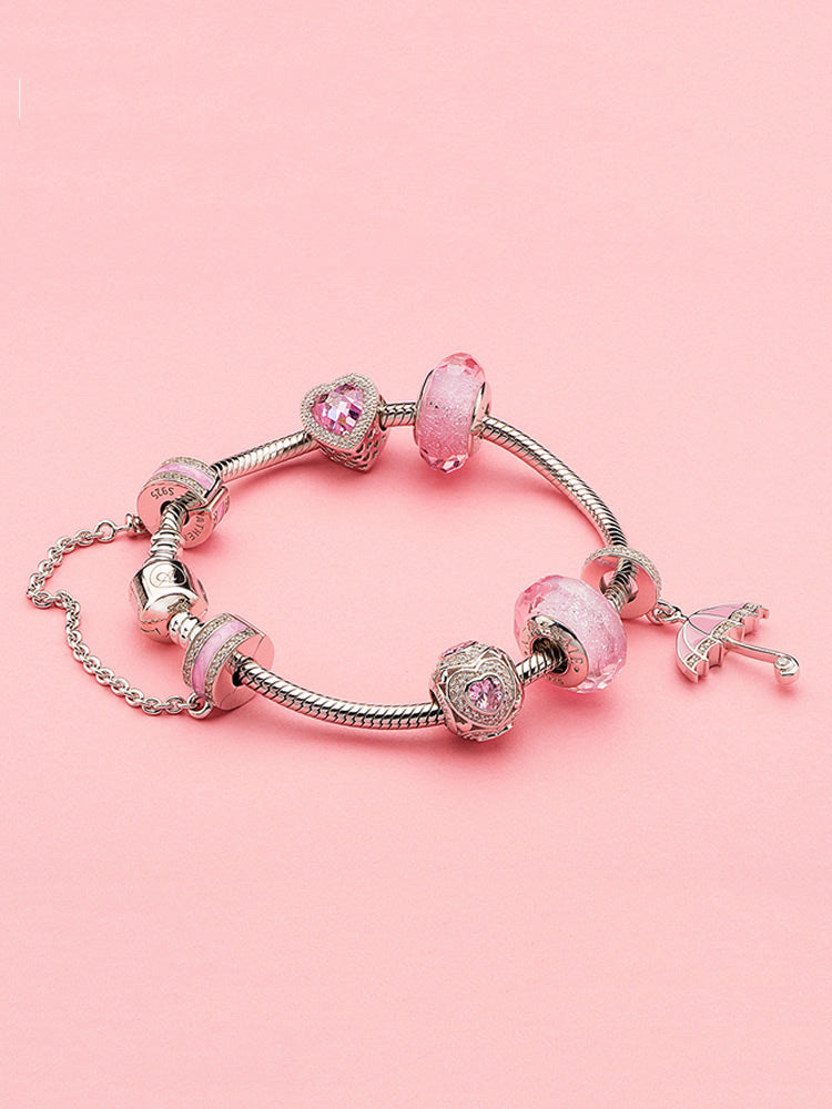 Silver safety chain charm securing charm bracelet
