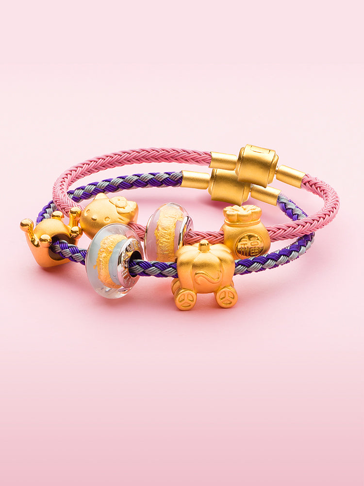 Braided charm bracelet with gold clasp styled with charms
