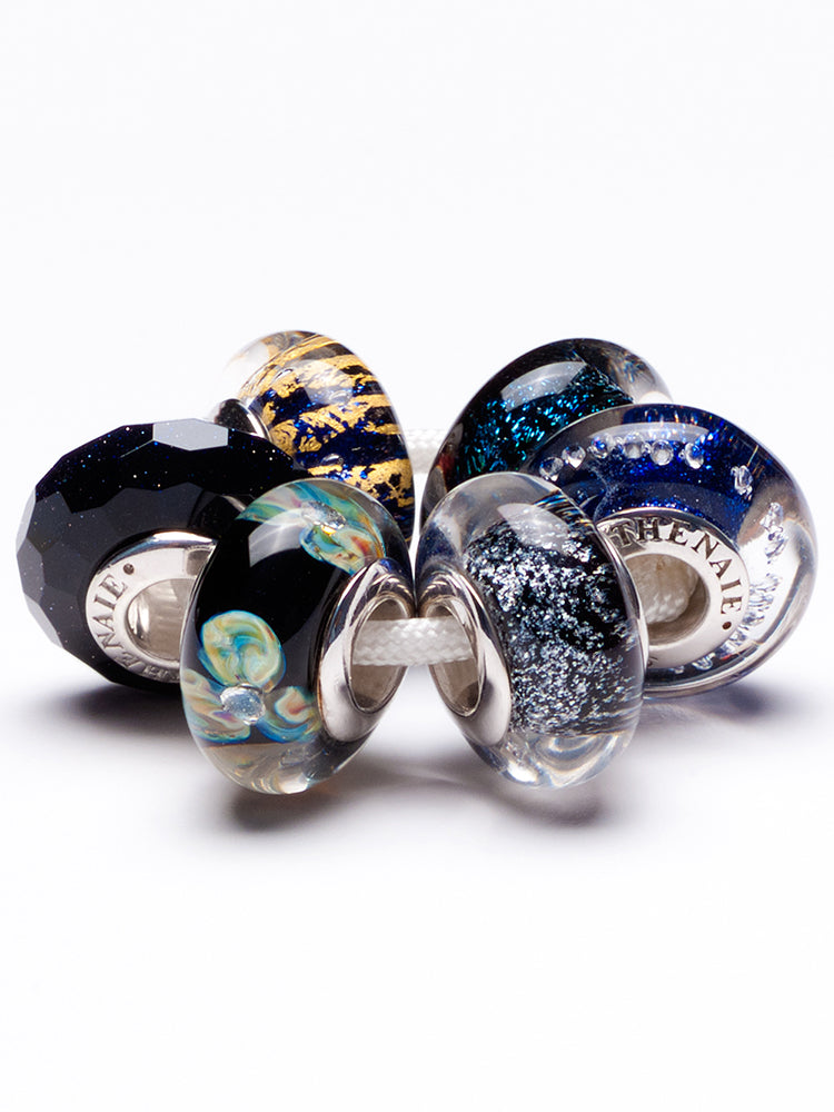 Close view of celestial driftmist murano glass charm on European charm bracelet