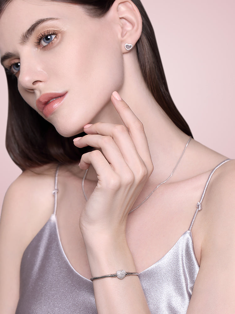 Charm bracelet with heart clasp styled for everyday wear