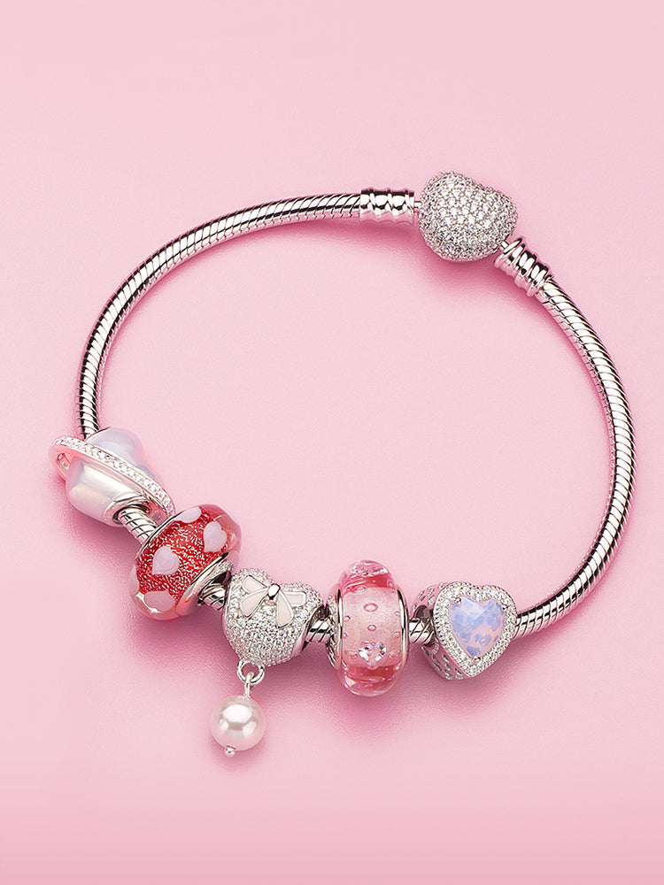 Sterling silver charm bracelet styled with multiple charm beads