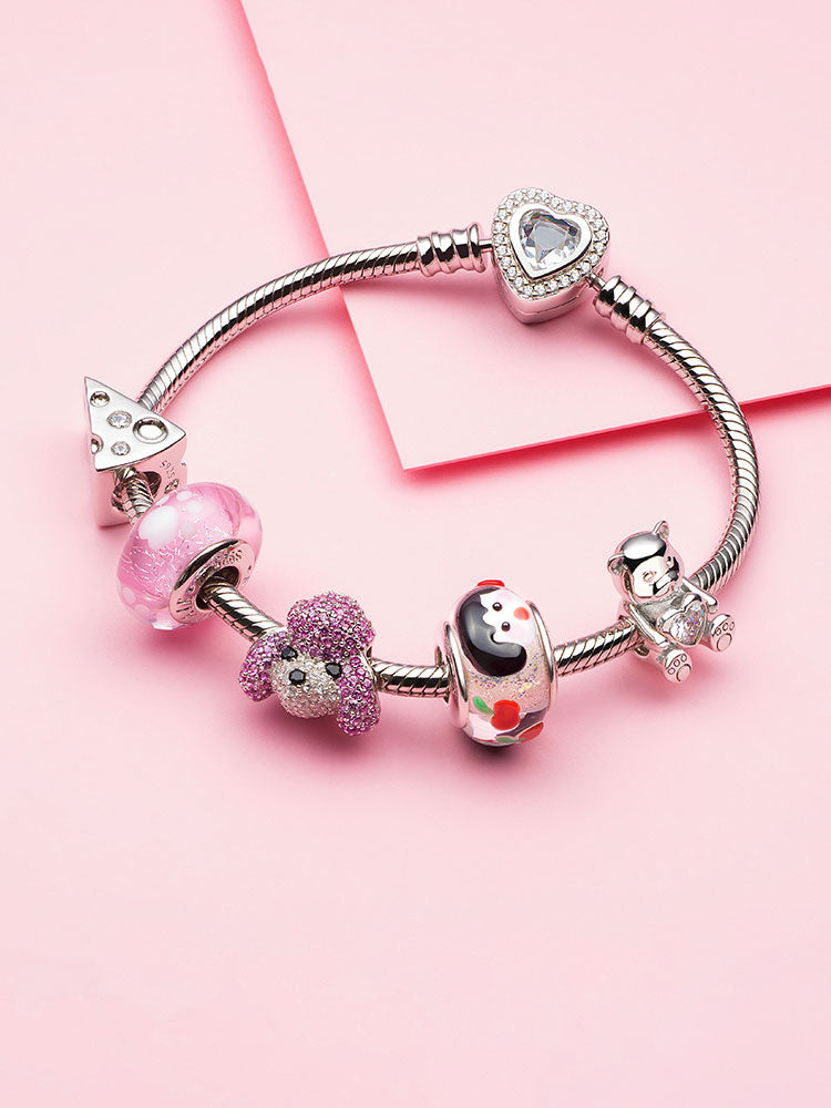 Charm bracelet with pink Murano glass beads and silver charms
