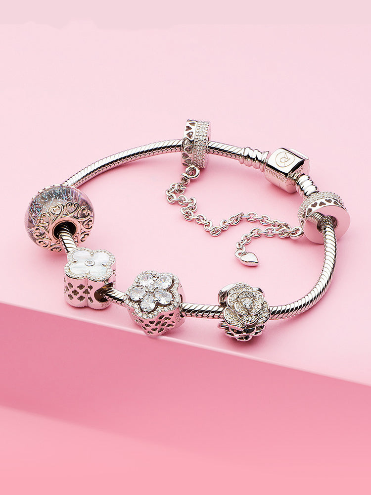 Pearl Clover charm bead styled on charm bracelet with silver charms