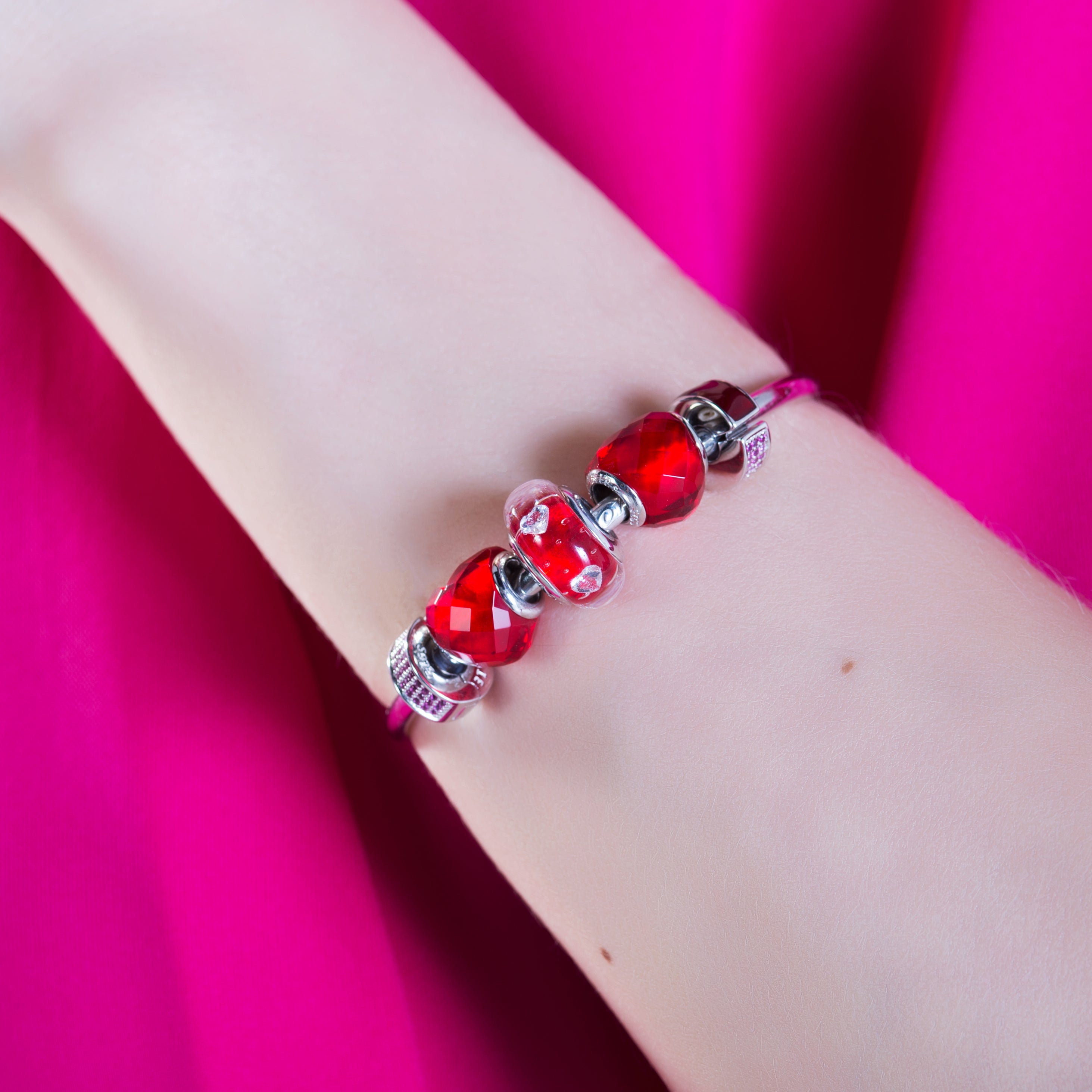Model wearing Berry Spark Clip Charm on bracelet
