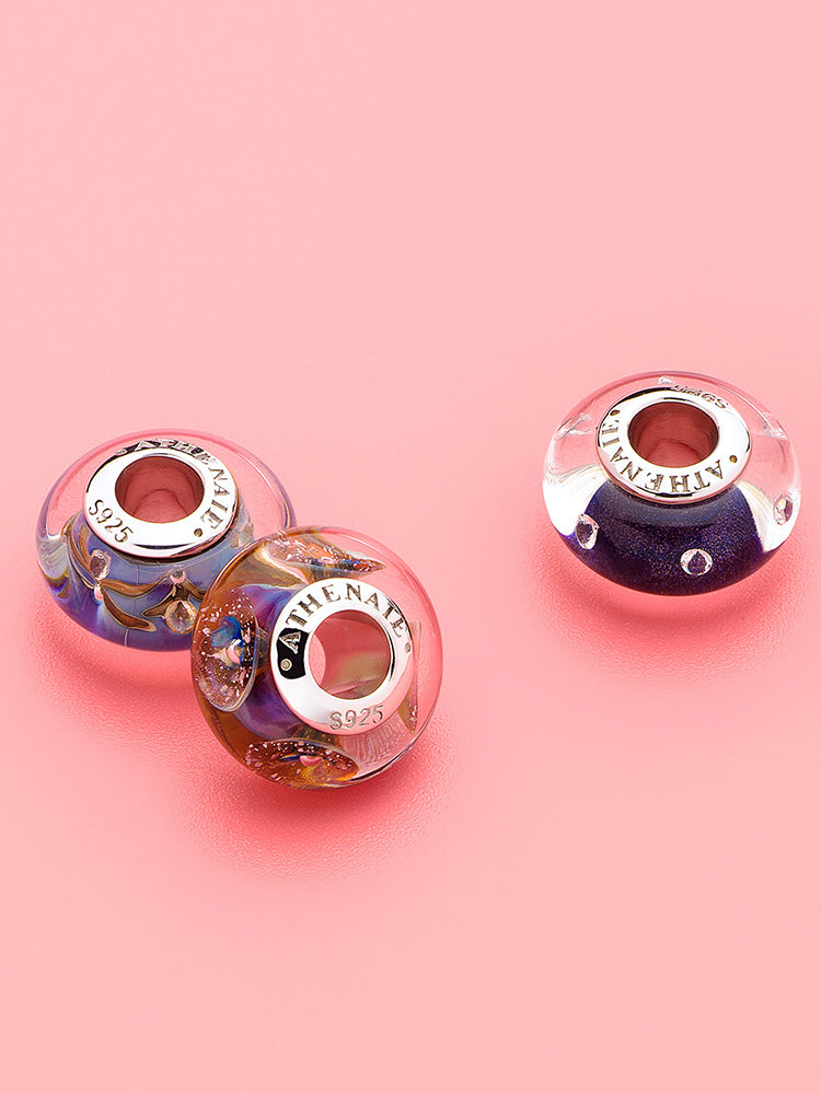 Cosmic bloom murano glass charm styled on sterling silver charm bracelet