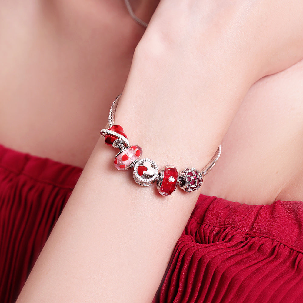 Model wearing Crimson Heart Murano glass charm with charm bracelet, romantic red glass jewelry gift for her
