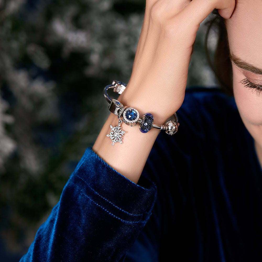 Model wearing Crystal Snowflake pendant charm on silver bracelet – festive winter jewelry design