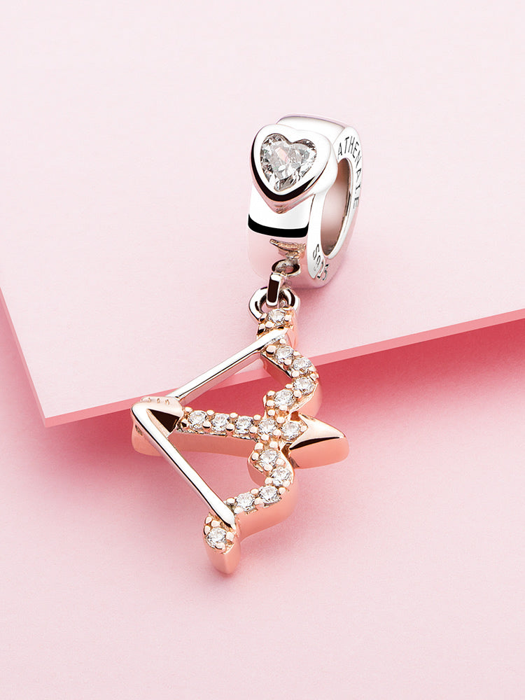 Cupid's arrow pendant charm styled on charm bracelet