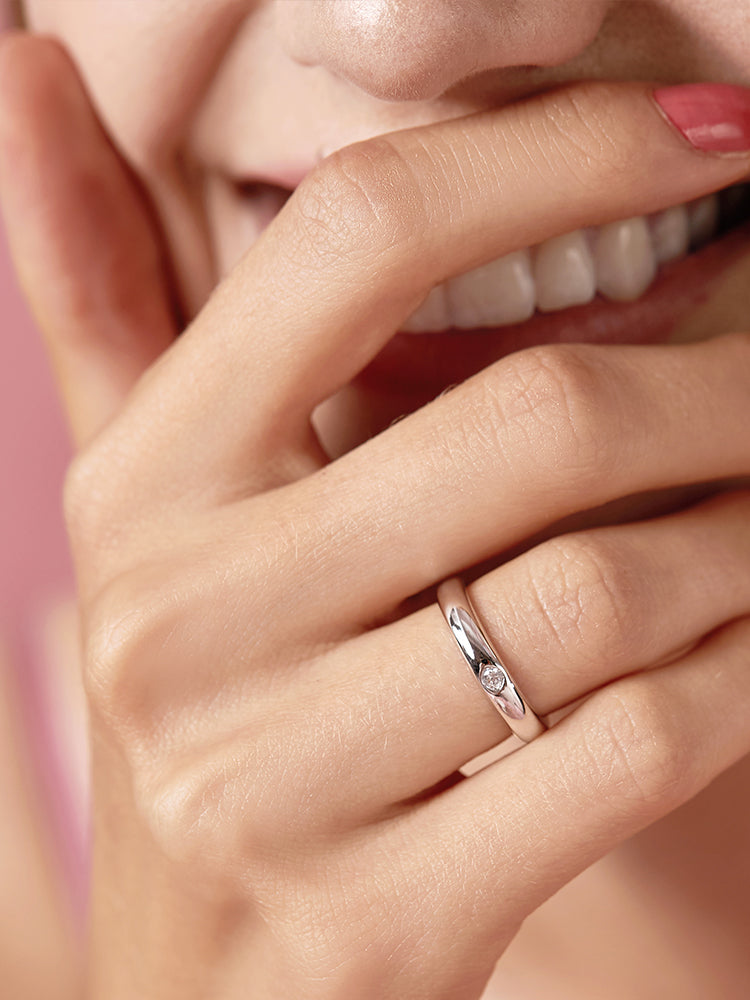 Dainty sterling silver bezel CZ minimalist ring worn on hand