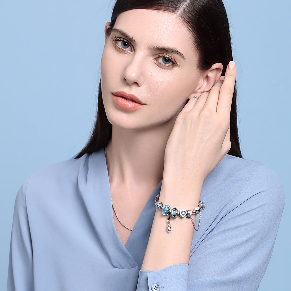 Dolphin Dance charm on wrist, Murano glass with 925 silver, playful dolphin ocean jewelry