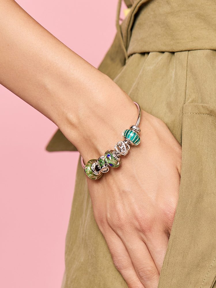 Royal Feather Murano glass charm bead worn on bracelet by model