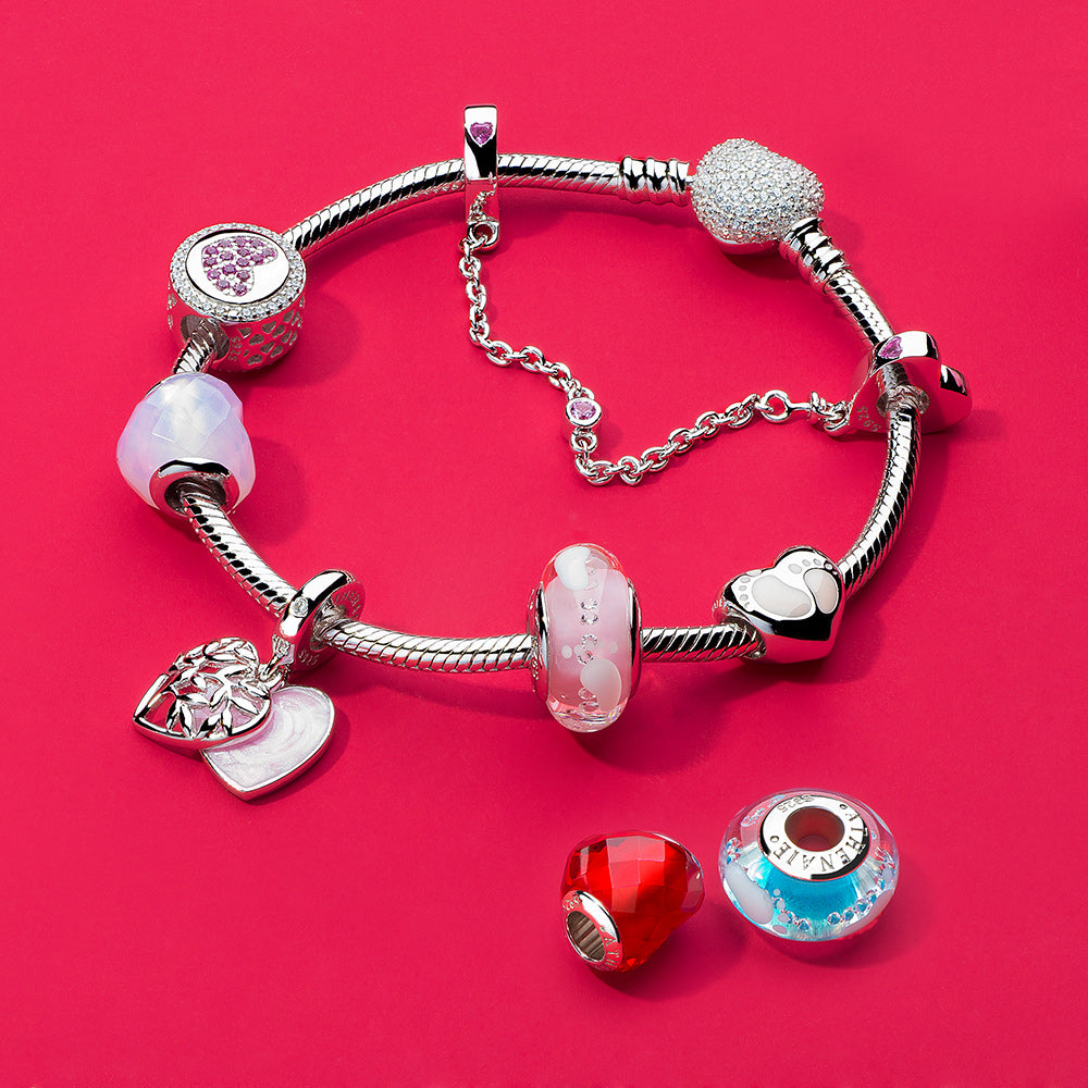 Complete charm bracelet styled with First Step baby footprint Murano glass bead