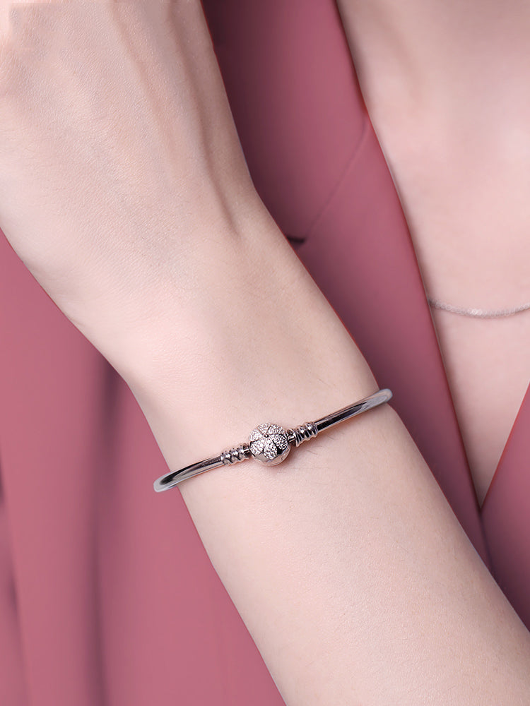 sterling silver floral clasp charm bangle bracelet worn on wrist