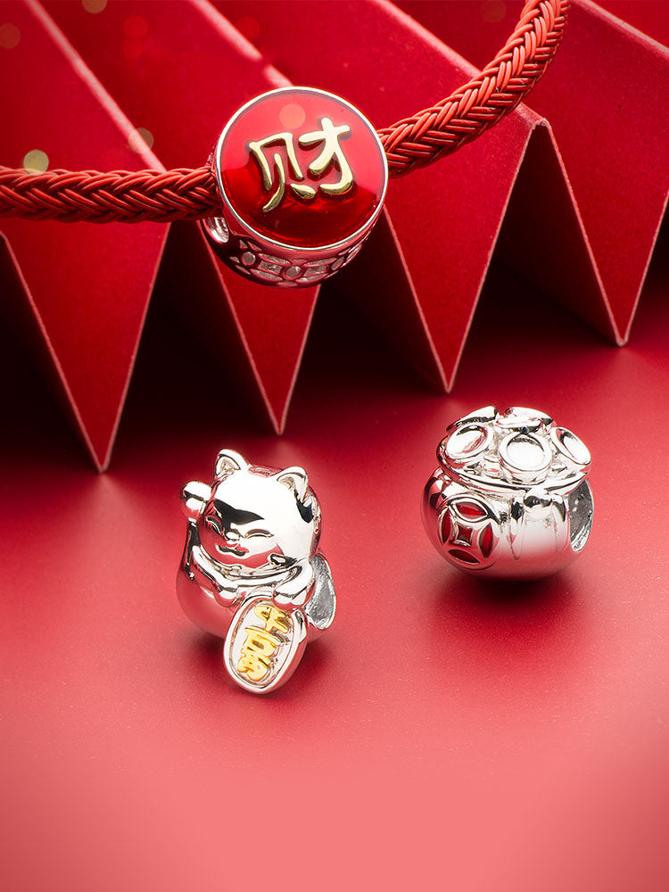 Fortune bag charm bead detail with symbolic lucky design