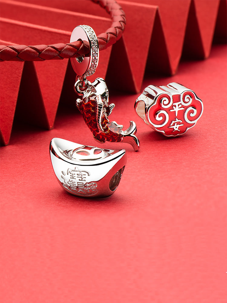 Fortune ingot charm bead styled on charm bracelet symbolizing prosperity