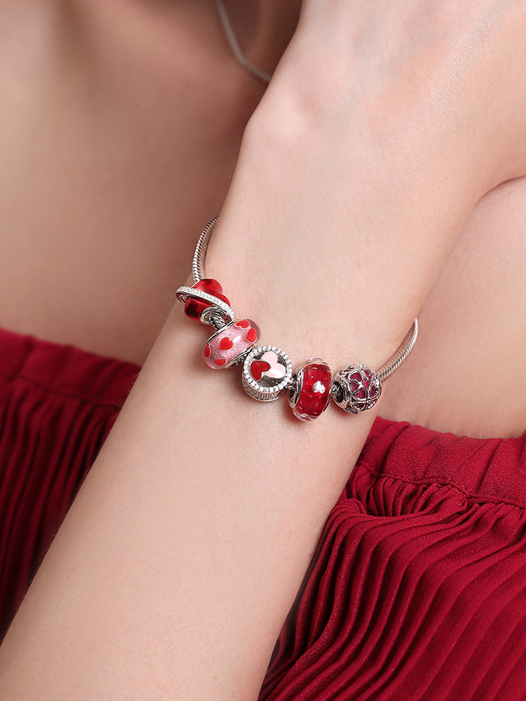 Model wearing bracelet with Crimson Four Leaf Clover charm bead