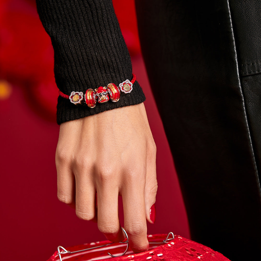 Model wearing God of Wealth charm bead on silver bracelet, symbolizing prosperity and good fortune