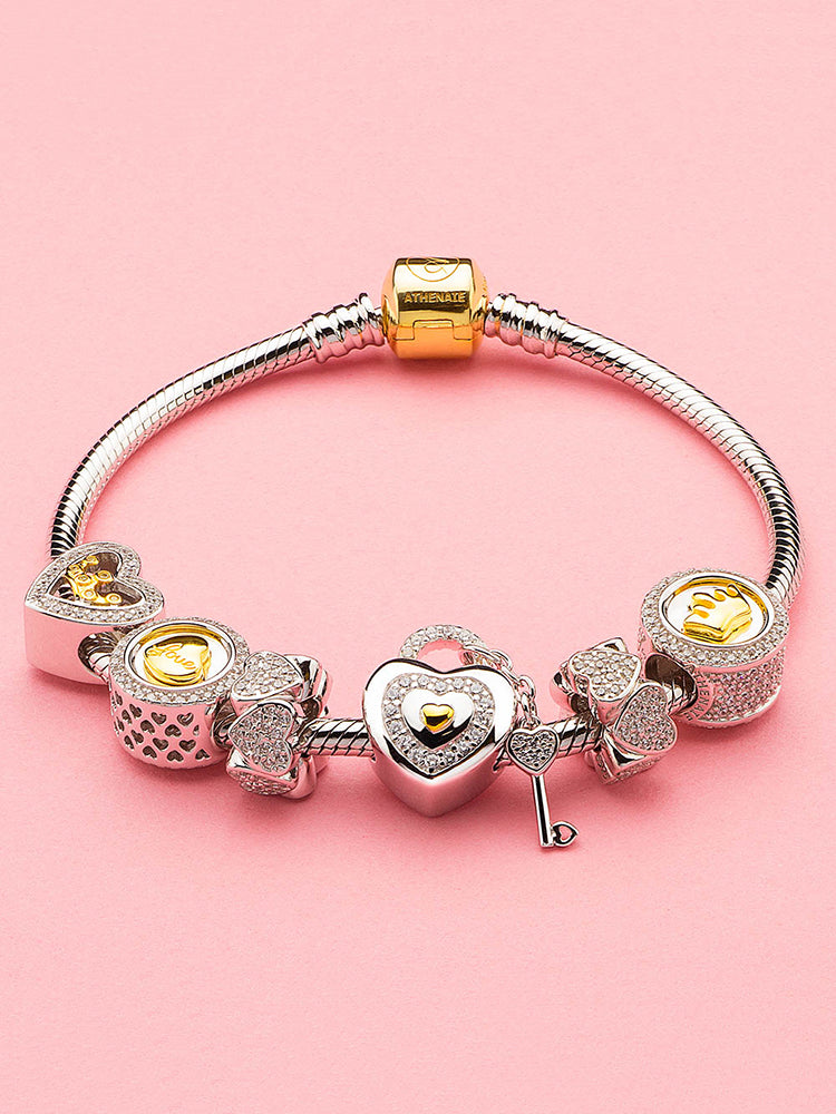 Gold-tone crown charm styled on a charm bracelet