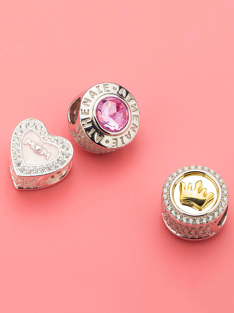 Gold-tone crown charm shown with other charms