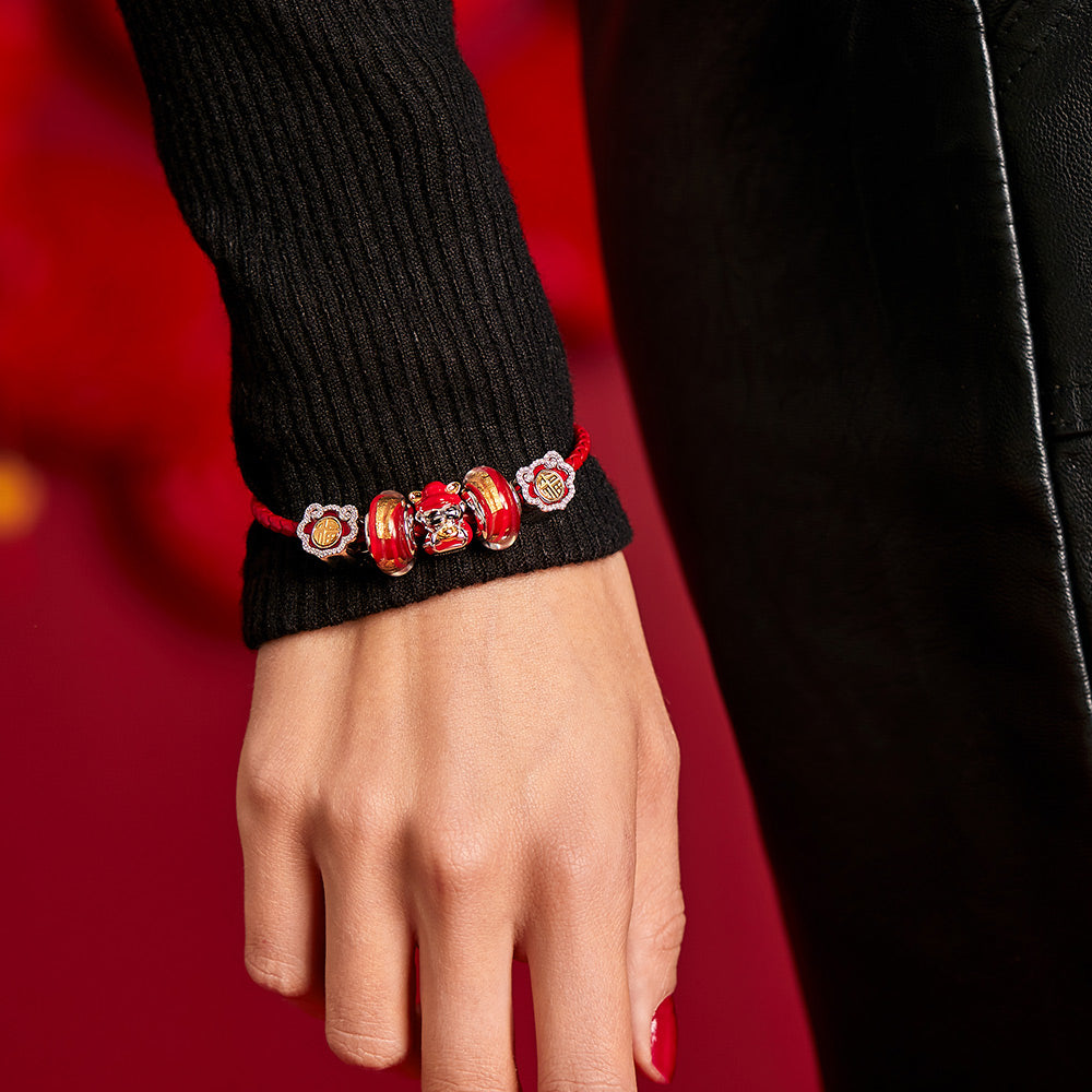 Close-up of Golden Flame Murano glass charm bead on model bracelet