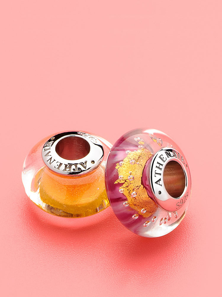 Golden halo murano glass charm styled on sterling silver charm bracelet