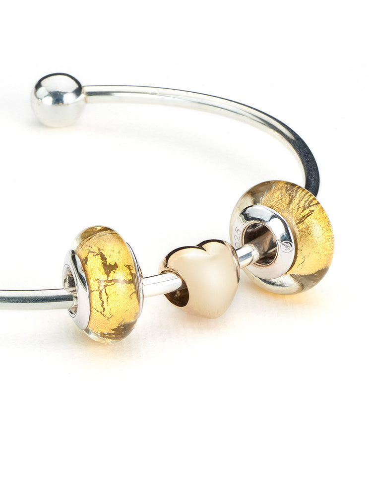 Golden halo murano glass charm paired with snake chain bracelet