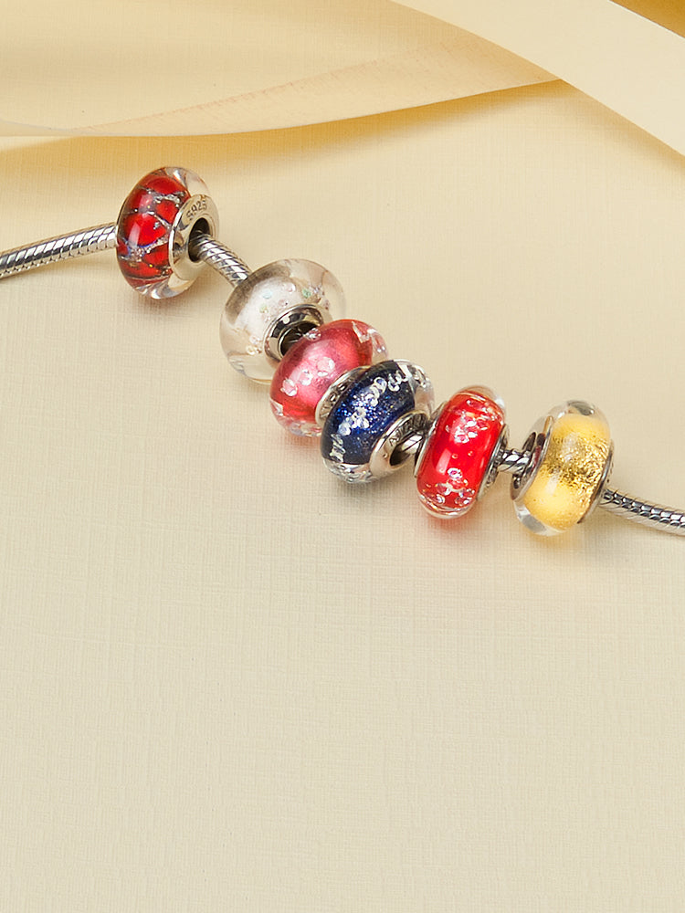 Close view of golden halo murano glass charm on silver bracelet